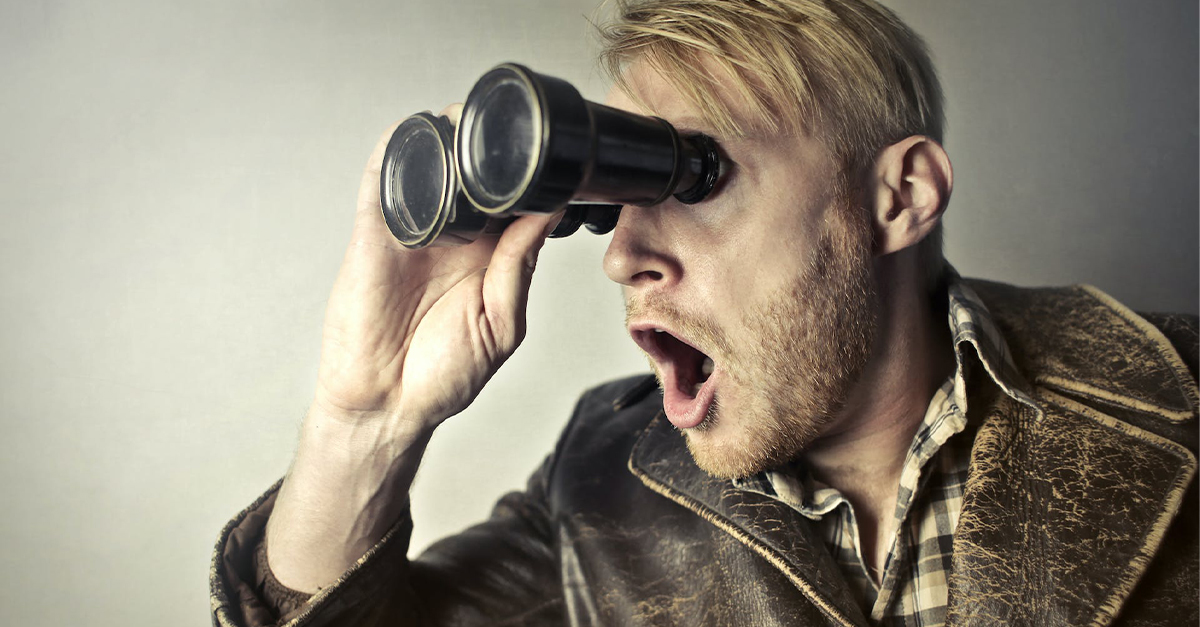 Man in Brown Leather Jacket Using Binoculars