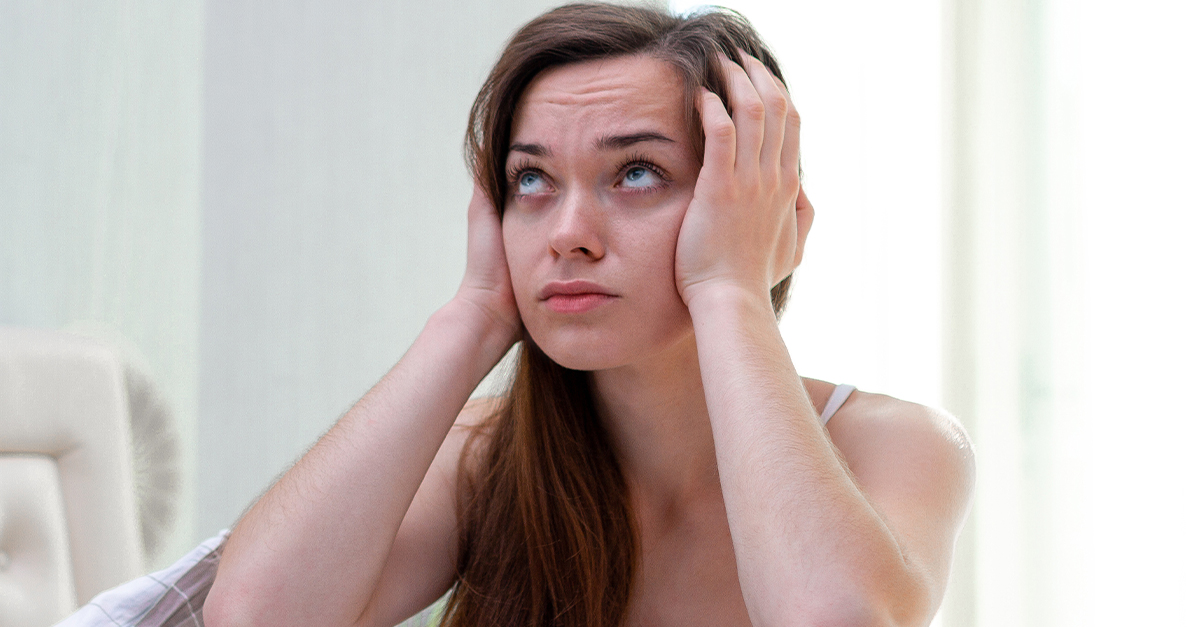 girl putting her hands over her ears