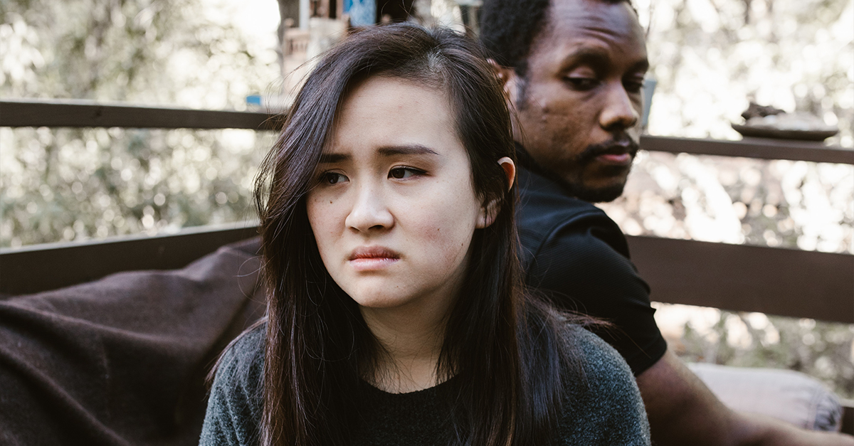 An Upset Woman Sitting Beside the Man