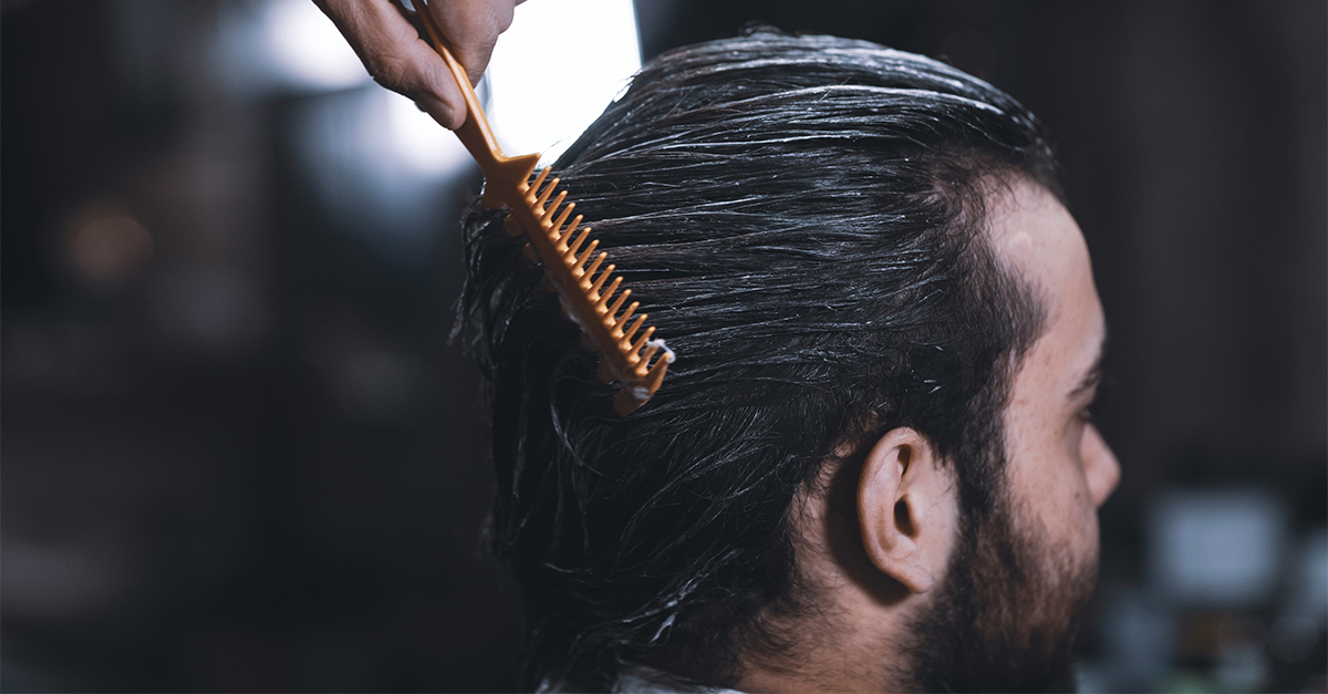 barber combing man's hair