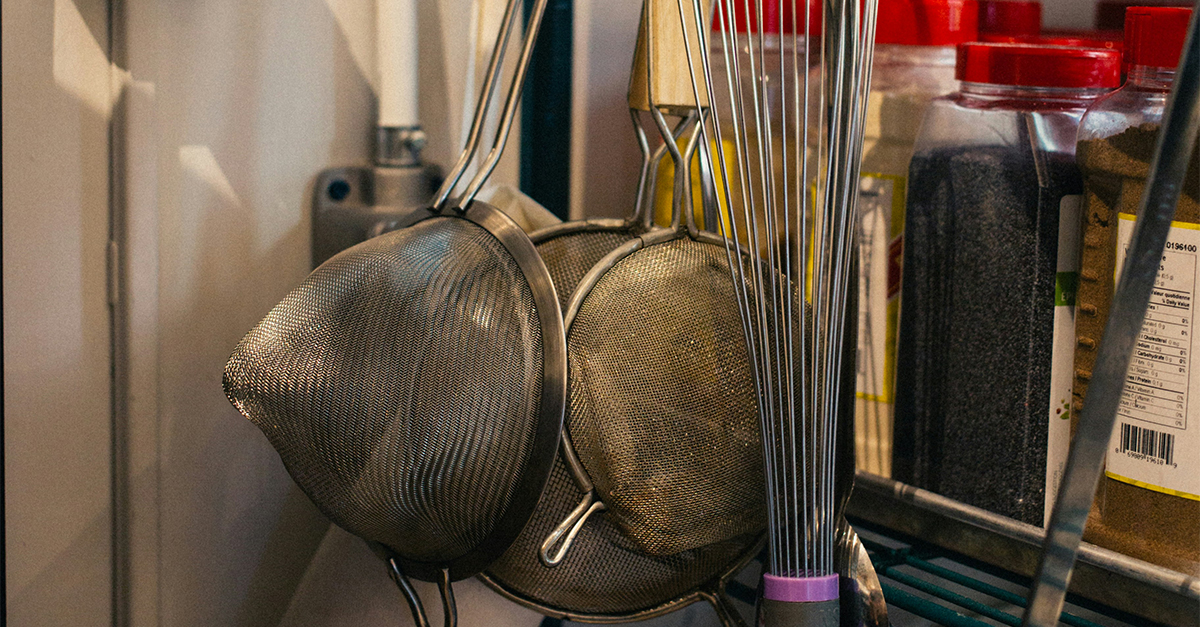 variety of kitchen tools including strainers