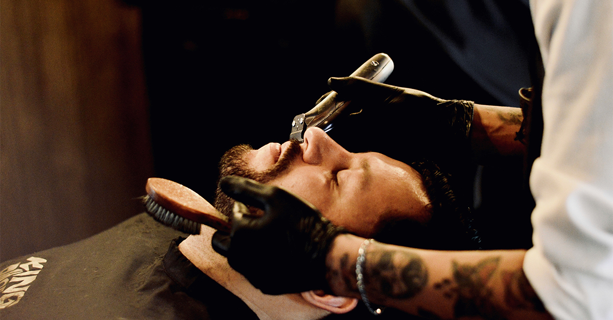 barber shaving a man