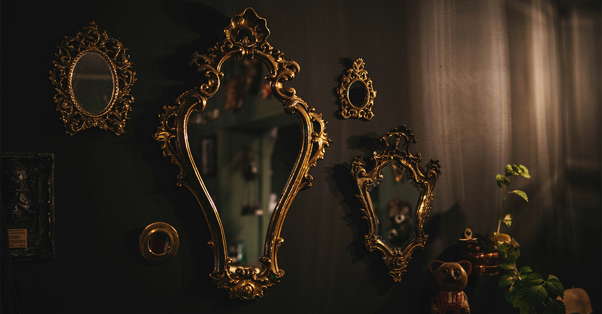 gold framed mirrors hung on wall