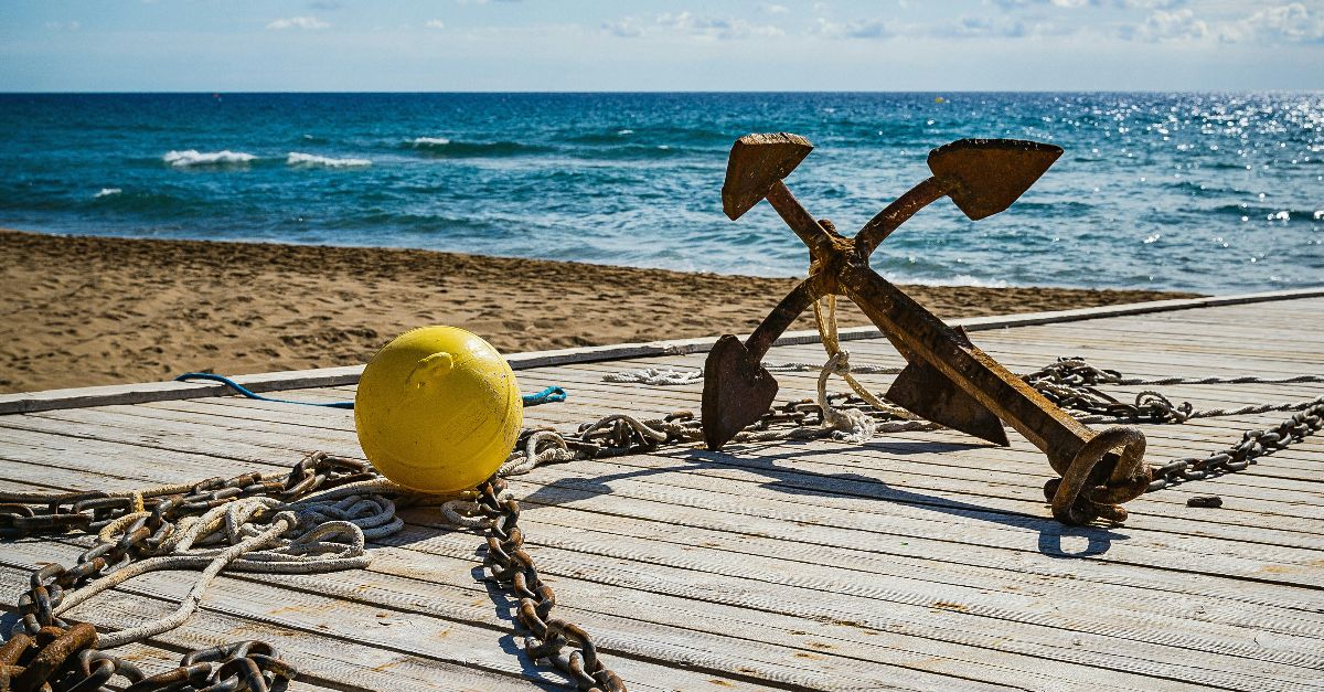 brown wooden cross on brown wooden dock during daytime