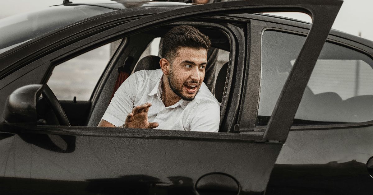 a person sitting on the seat of a car