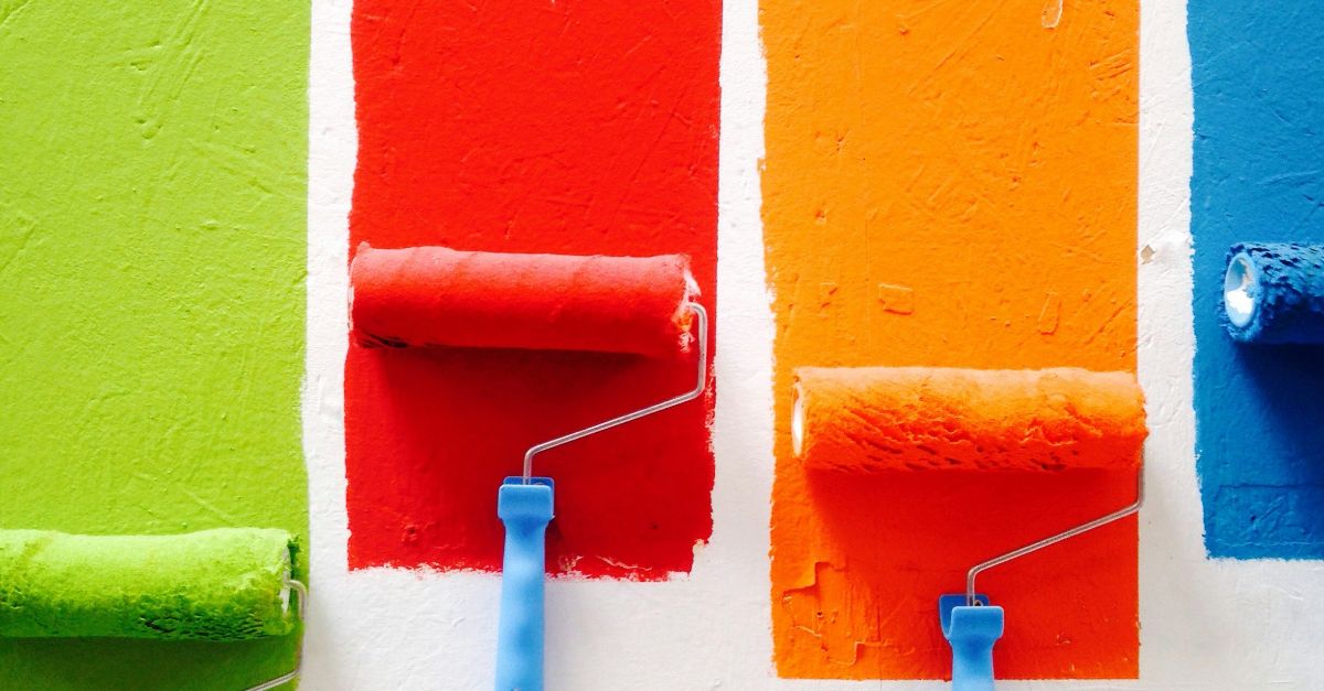 four orange, green, blue, and red paint rollers