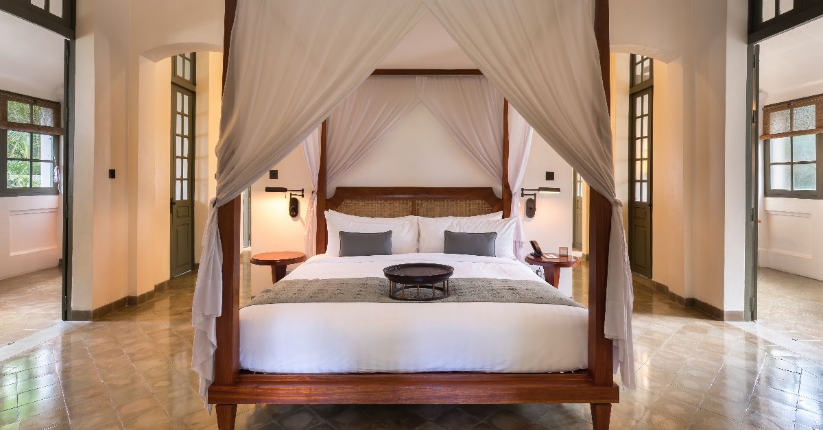 Canopy bed of Amantaka Suite in Amantaka luxury resort and hotel in Luang Prabang, Laos. Amantaka is one of the 34 properties operated by Aman Resorts, hospitality company founded by Indonesian hotelier Adrian Zecha in 1988, present in more than 20 countries. The hotel, located in a French colonial building, opened in September 2009. A boutique hotel, it contains 24 lavish suites, encircling a central courtyard and is designed with a mixture of traditional Lao furnishings and modern. The suites range in size from 70 to 120 square metres and include eight suites, four pool suites, eight Khan pool suites, two Mekong pool suites and two Amantaka pool suites. All of the rooms have a king-sized bed centre of the suites beneath a traditional high ceiling. They are painted in white and have mahogany or dark wood furnishings and windows. The rooms are reported to be between 1,100 USD and 1,900 USD a night.