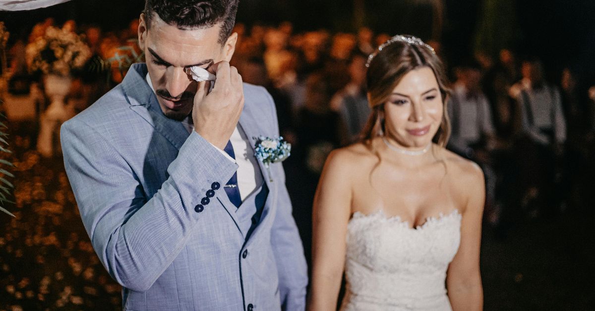 Bride and groom share an emotional moment during their wedding ceremony.