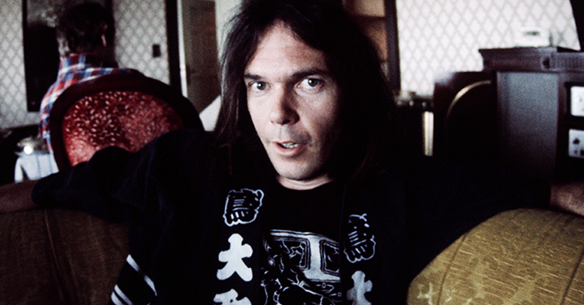Neil Young in happi-coat relaxing at a hotel, Tokyo, March 1976.