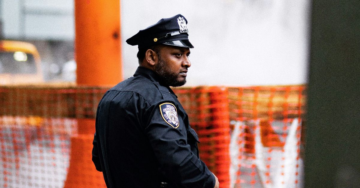 chief standing near body of water