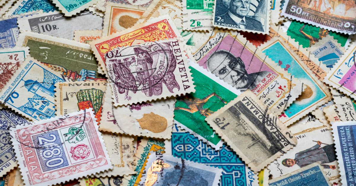assorted postage stamps on blue and white textile